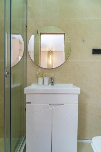 a bathroom with a sink and a mirror at Tashrabat Hotel in Karakol