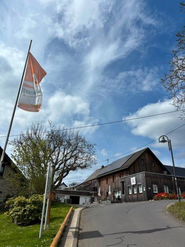 a flag on a pole in front of a building at Race & Rest Apartments in Baar
