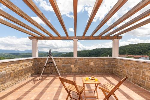 a camera on a roof with a table and chairs at Villa Dol in Buzet