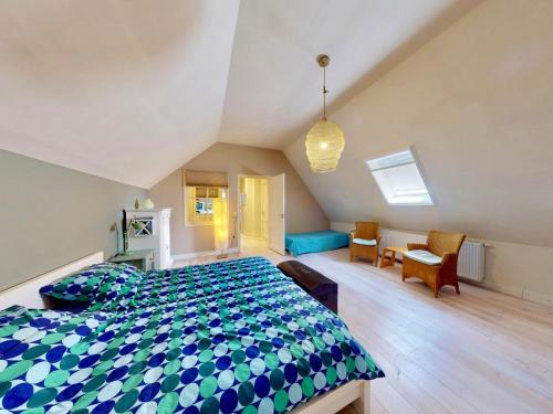 a bedroom with a bed and a desk and chairs at Vakantie appartement Erve de Wezel in Diepenheim