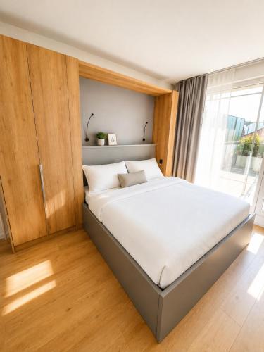 a large bed in a room with a window at AH Terrace Jacuzzi Suite near Arena in Košice