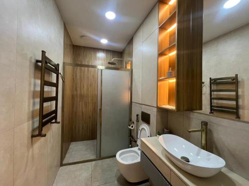 a bathroom with a sink and a toilet and a shower at Sea Breeze Polo in Nardaran