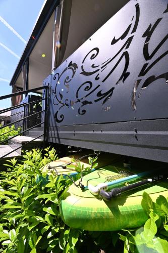 a surfboard sitting on top of some plants at L&A Mobile House in Metlika