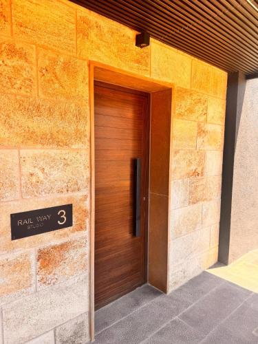 a wooden door on the side of a building at Railway studio 3 - Luxury Suite in Byblos - Central & Relaxing in Jbeil