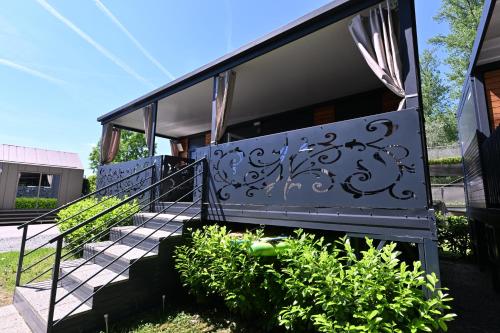 a staircase leading up to a house with graffiti on it at L&A Mobile House in Metlika