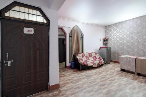 a living room with a large door and a couch at SPOT ON Hotel prayag villa in Allahābād