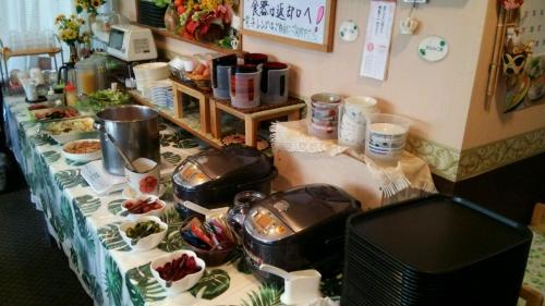 a table topped with dishes and food on a table at Business Hotel Goi Hills in Ichihara