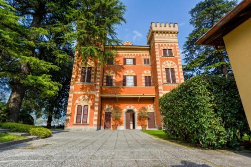 an orange brick building with a tower at Lenno Giardinetto in Lenno