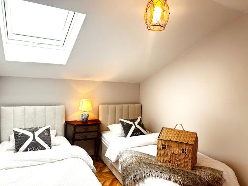 a attic bedroom with two beds and a skylight at American Dream Villa in Łazory
