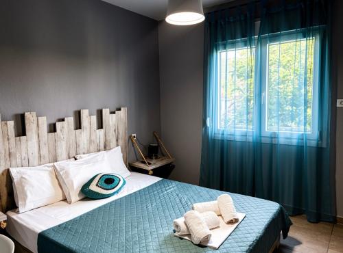 a bedroom with a bed with towels and a window at Aegli House in Theológos