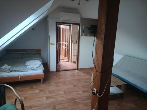 a bedroom with a bed and a stairway with a door at Apartmán Penzion Sigma in Dolní Žďár