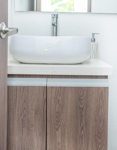 a sink on top of a wooden bathroom vanity at Ginebra central laureles estadio in Medellín