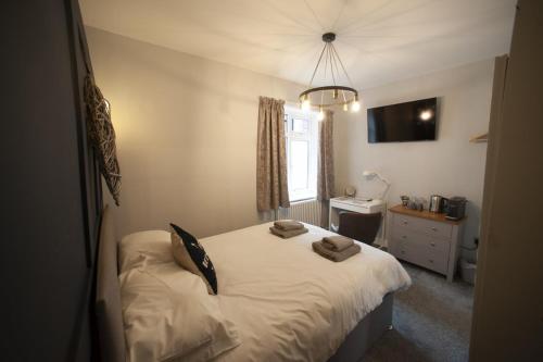 a bedroom with a bed with two pillows on it at Modern Studio - Central Location in Southport