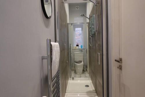 a small bathroom with a toilet and a sink at Modern Studio - Central Location in Southport