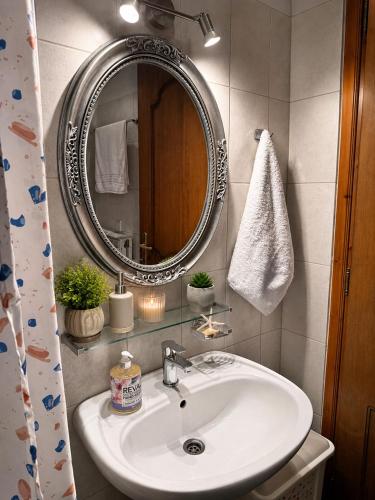 a bathroom with a sink and a mirror at Villa Evgenia(Leonidas) in Ierissos