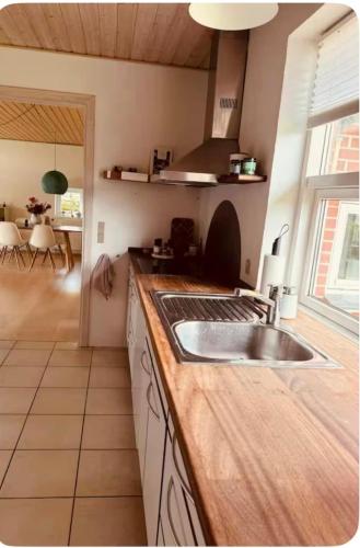 a kitchen with a sink and a counter top at Cozy house in Hasseris in Aalborg