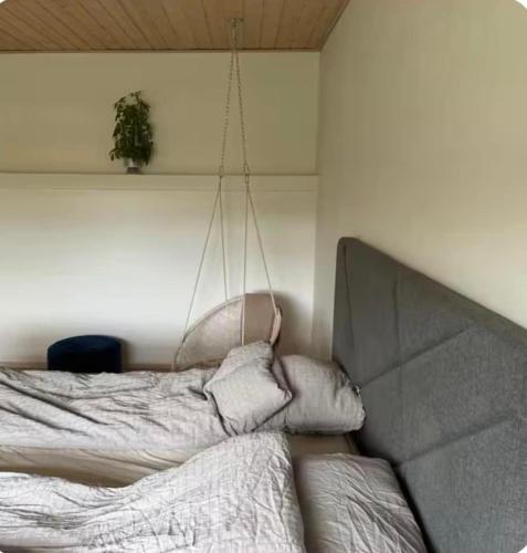 a bedroom with a bed and a couch at Cozy house in Hasseris in Aalborg