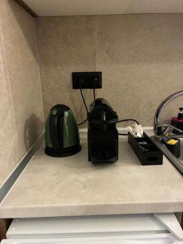 a green helmet sitting on top of a counter at Thanos ,Rooms and Apartments in Ouranoupoli
