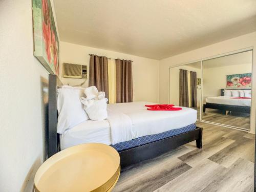 a hotel room with a bed and a mirror at Charming 2nd Ave Lofts in Downtown San Diego with Parking in San Diego