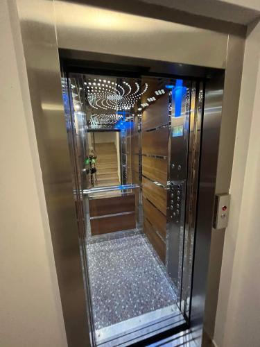 a bathroom with a walk in shower with a mirror at The Lighthouse Suite in Mamaia Sat/Năvodari
