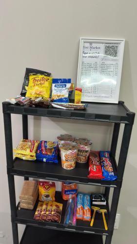 a shelf filled with different types of food at Mini apê de luxo montese in Fortaleza