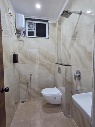 a bathroom with a shower and a toilet and a sink at The Sanctuary by exot in Visakhapatnam