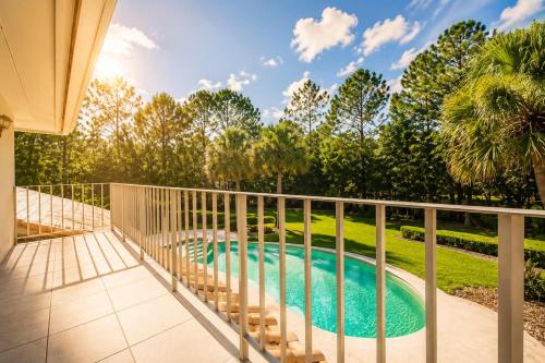 a balcony with a swimming pool and a fence at SWISS 41 - Golf Course in Clermont