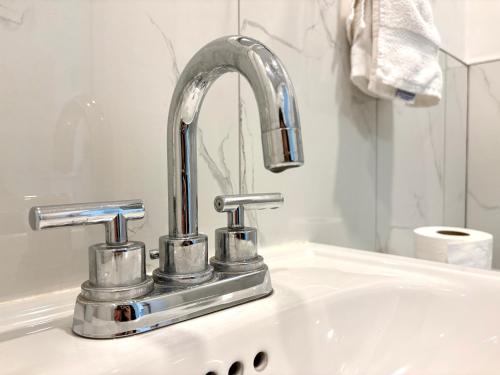 a bathroom sink with a chrome kitchen faucet at Hotel La Residence du Voyageur in Montreal