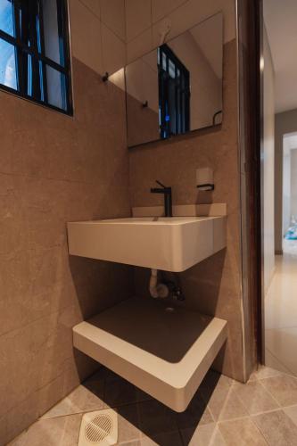 a bathroom with a sink and a mirror at Smart Luxury Apartment, Bunga in Kampala