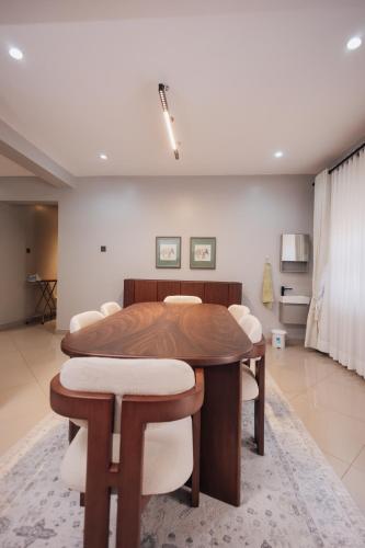 a dining room with a table and some chairs at Smart Luxury Apartment, Bunga in Kampala