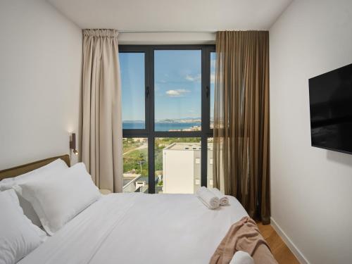 a bedroom with a bed and a large window at NS Luxury Villas in Podstrana