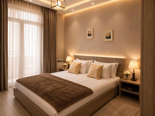 a bedroom with a large bed and a window at Vazi Aparthotel in Tbilisi City