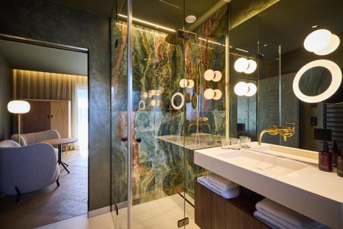 a bathroom with a sink and a mirror at nōa Schladming in Schladming