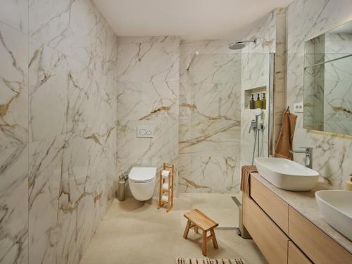 a bathroom with a toilet and a sink and a shower at NS Luxury Villas in Podstrana