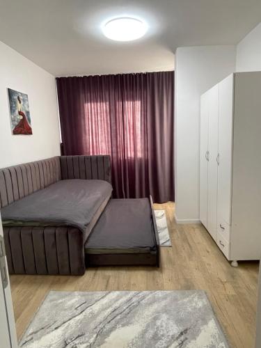 a living room with a couch and a window at Adora's Apartment in Peje