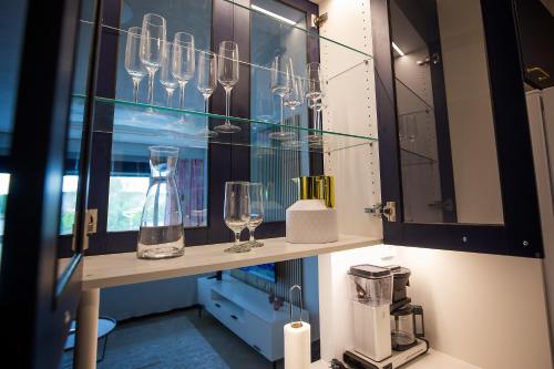 a glass display case with glasses on a shelf at Opera Magic Castle View, Air-Con, Free wifi in Savonlinna