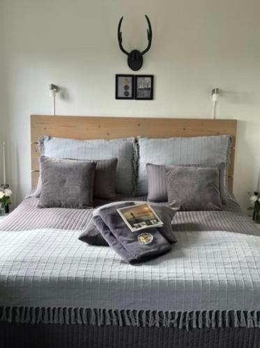 a bed with a blanket and a mirror on the wall at Lolland Bed & Breakfast in Søllested
