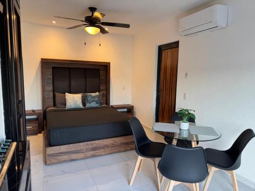 a bedroom with a bed and a table and chairs at Loft with Private Terrace in Tepic