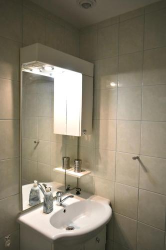 a bathroom with a sink and a mirror at Villa Paris in Piešťany