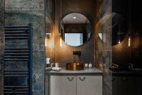 a bathroom with a sink and a mirror at Selenophile Villa with heated pool in Monolithos