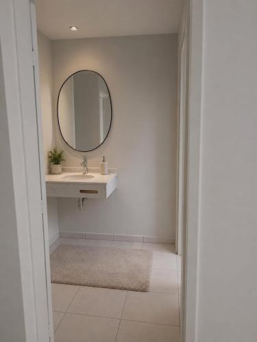 a bathroom with a sink and a mirror at ParaHouse in Joinville