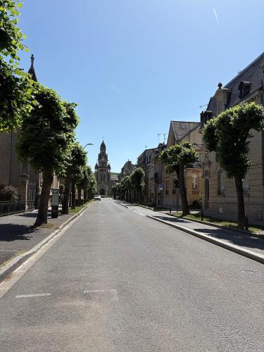 an empty street with a building in the distance at Salon Boyer in Épernay