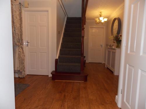 a hallway with a staircase and a stair case at Craig Eithin B & B in Holyhead