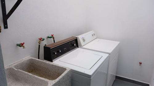 a kitchen with a dishwasher and a washer and dryer at Orion department in Tepic
