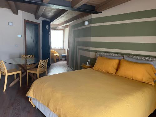 a bedroom with a large bed and a table at La Crevasse Morgex in Morgex
