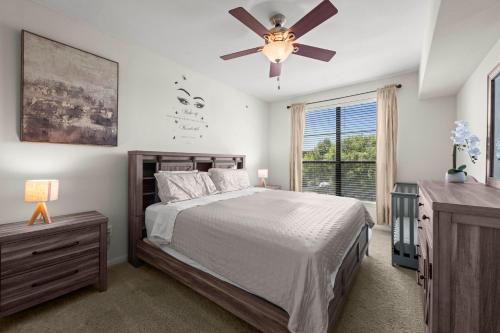 a bedroom with a bed and a ceiling fan at Spacious Blessed HOME for blessed guests at the Domain in Austin