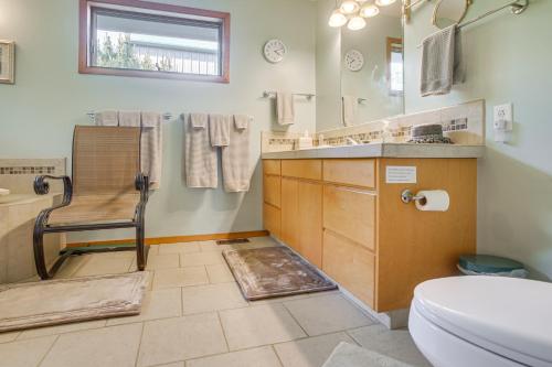 a bathroom with a toilet and a chair in it at Unique Home w/ Beautiful Mtn Views! in Sequim
