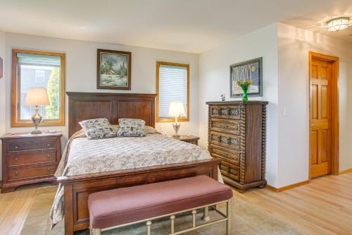 a bedroom with a bed and a wooden dresser at Unique Home w/ Beautiful Mtn Views! in Sequim