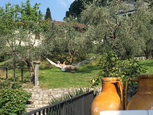 a man laying in a hammock in a yard at Castello Oldofredi in Monte Isola