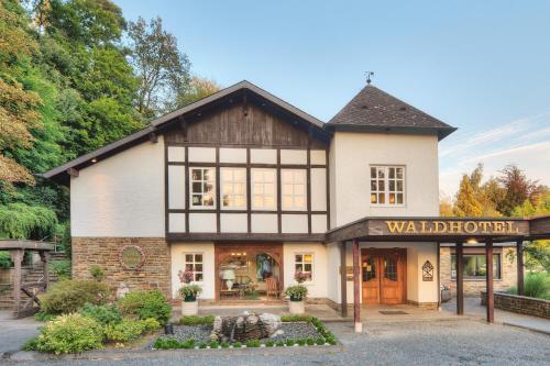 a building with a sign in front of it at Romantik Waldhotel Mangold in Bergisch Gladbach